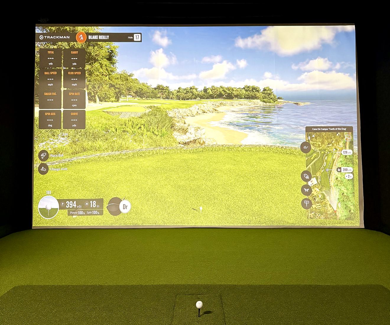 The Capital Golf Labs bay: a Trackman course on the impact screen with a ball teed up on the hitting mat