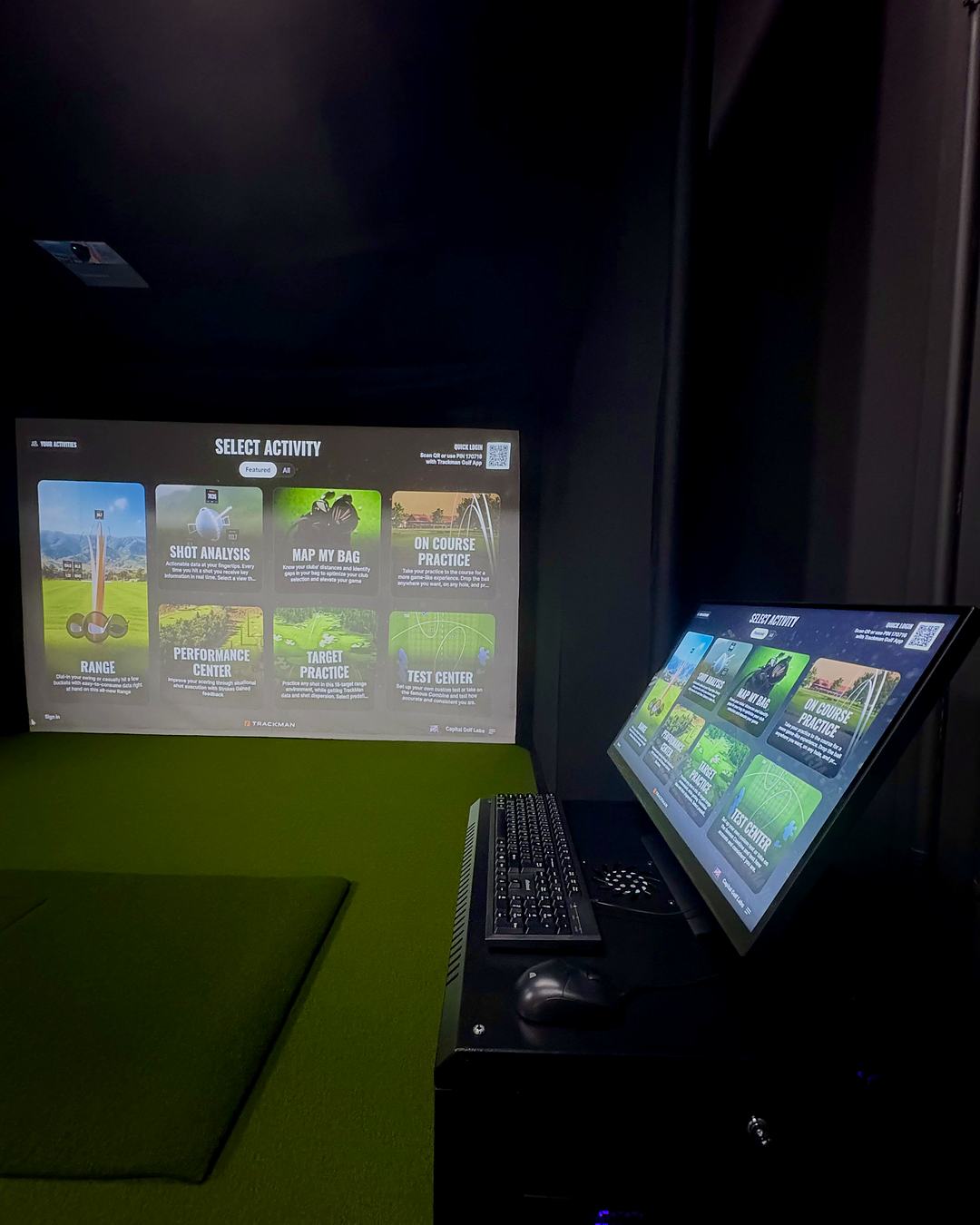 Side view of the bay with the Trackman activity menu on the screen and the touchscreen control station